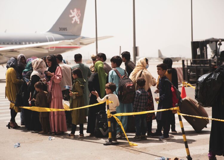 Civilians prepare to board a plane during an evacuation at Hamid Karzai International Airport, Kabul, Afghanistan August 18, 2021.