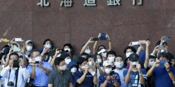 Japan further expands virus emergency areas as cases surge