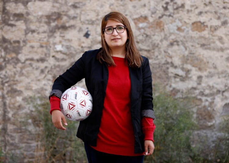 Afghan refugee Fanoos Basir, 25, a former player in the Afghanistan women's national soccer team, poses in front of the Razay reception centre for refugees in Piriac-sur-Mer following their evacuation from Afghanistan last week, France, August 30, 2021.