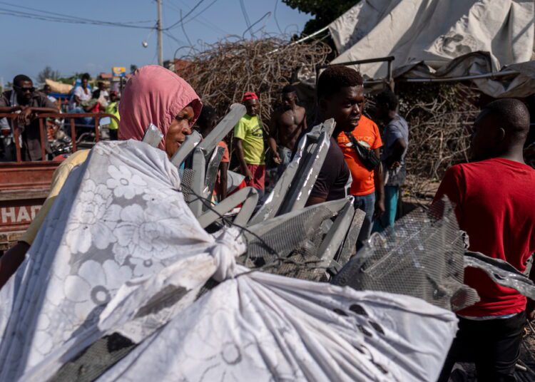 ‘I’m distraught’: grieving Haitians bury their dead a week after quake 1 - Egyptian Gazette A man carries a pile of aluminium scavenged from houses destroyed after last week's 7.2 magnitude quake to a metal recycler, in Les Cayes, Haiti.