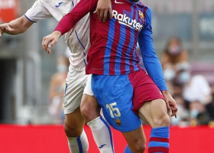 Barcelona's Clement Lenglet (R) and Getafe's Jaime Mata vie for the ball during their Spanish La Liga match.