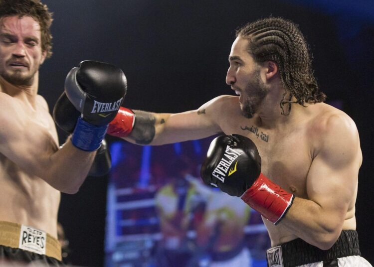 Nico Ali Walsh (R) faces Jordan Weeks during a middleweight boxing bout near Tulsa, Oklahoma.