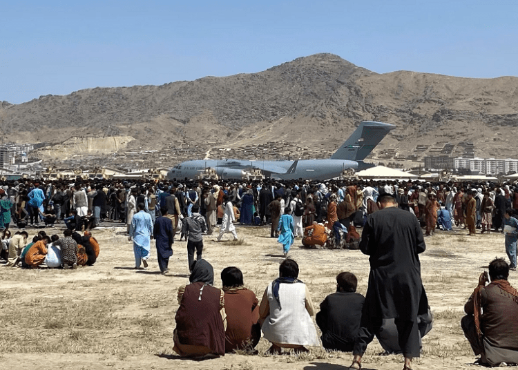 The Taliban fired in the air and used batons to make people line up in orderly queues outside Kabul airport on Sunday