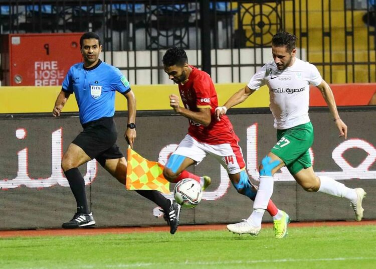 Al-Ahly’s right winger Hussein el-Shahat (L) vying for the ball against Al-Masry defender during their match in the Egyptian Premier League.