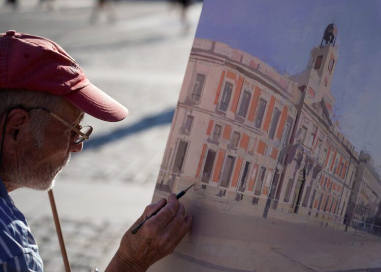 Spanish artist Antonio Lopez working during a session to paint the famous Puerta del Sol square in Madrid.