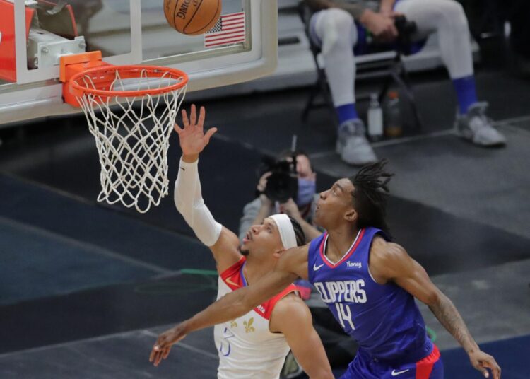 New Orleans Pelicans guard Josh Hart (L) gets past LA Clippers guard Terance Mann for two points during the second quarter of the game in New Orleans on March 14, 2021.