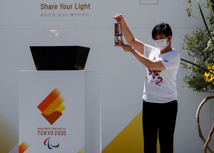 Tokyo governor Yuriko Koike holds the Paralympic torch lantern during the flame gathering event to merge flames collected from 62 municipalities within the Japanese capital into one, in Tokyo August 20, 2021.