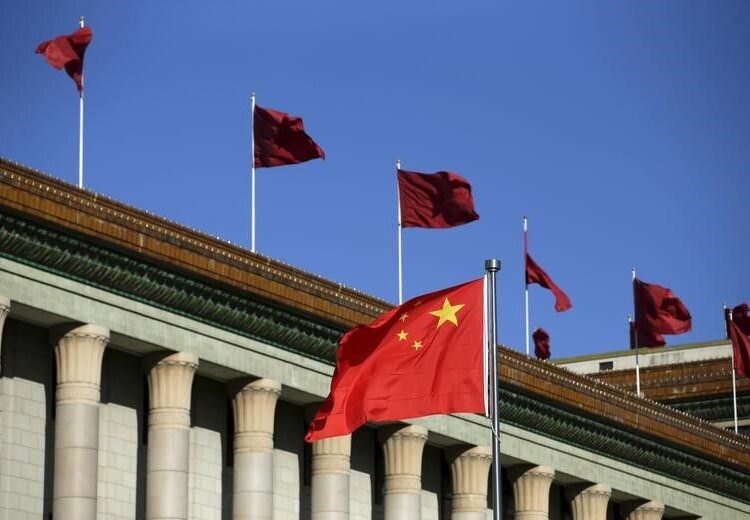 Chinese flag waves in front of the Great Hall of the People in Beijing, China, October 29, 2015.  REUTERS/Jason Lee
