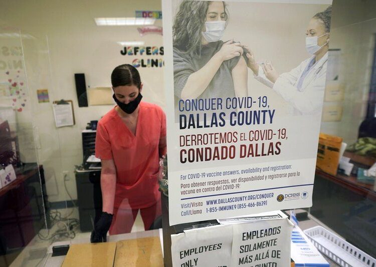 A Dallas County Health and Human Services nurse completes paperwork after administering a Pfizer COVID-19 vaccine at a county run vaccination site in Dallas, on Aug. 26, 2021.