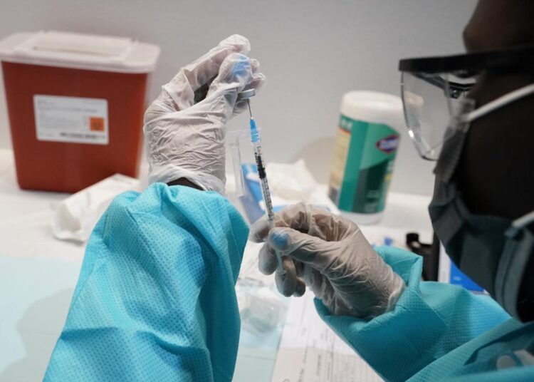 Photo shows health care worker fills a syringe with the Pfizer COVID-19 vaccine at the American Museum of Natural History in New York on July 22, 2021.