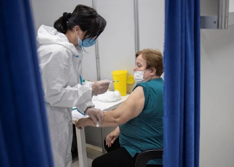 A woman gets a shot of vaccine against the coronavirus disease (COVID-19) in the Usce shopping mall, where the first 100 vaccinated will receive a discount voucher worth 3,000 dinars ($30.74) secured by mall's management and retailers, in Belgrade, Serbia, May 6, 2021.