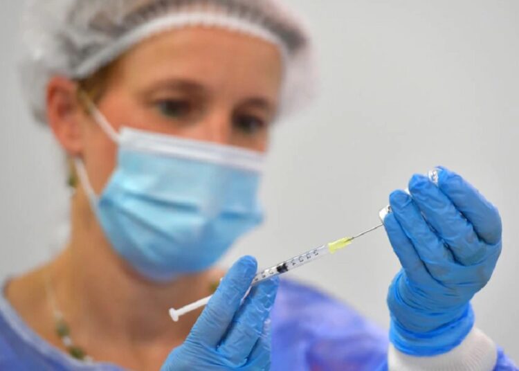 A nurse draws a dose of the BioNtech vaccine against coronavirus disease (COVID-19) at a vaccination centre at the Dresden Fair, in Dresden, Germany, July 29, 2021.
