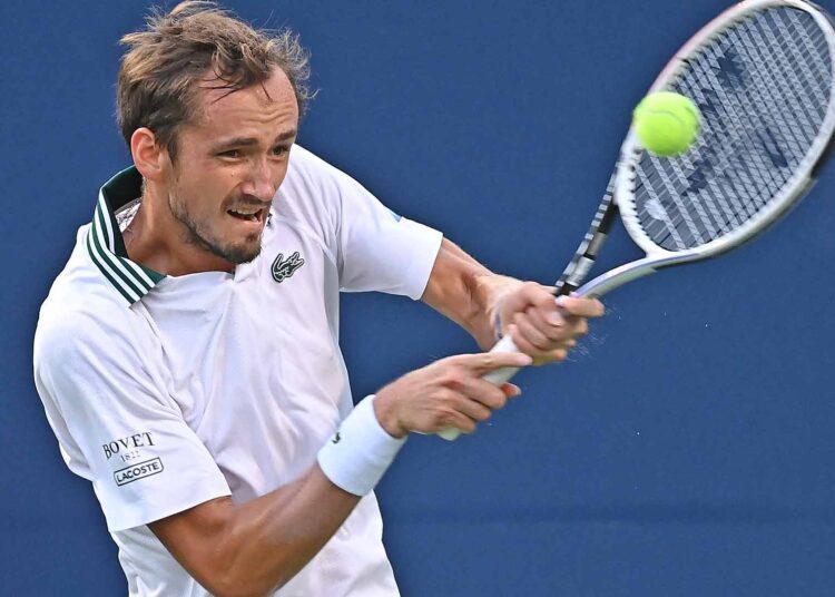 Daniil Medvedev of Russia hits a return to Grigor Dimitrov of Bulgaria during the Western & Southern Open tournament in Mason, Ohio.