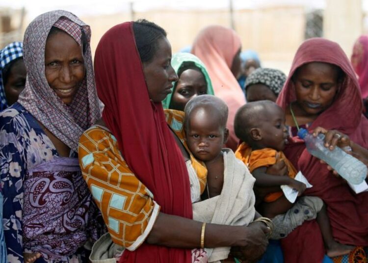 A file photo of women waiting with their children under a shed for food rations at a internally displaced persons (IDP) camp on the outskirts of Maiduguri, northeast Nigeria.