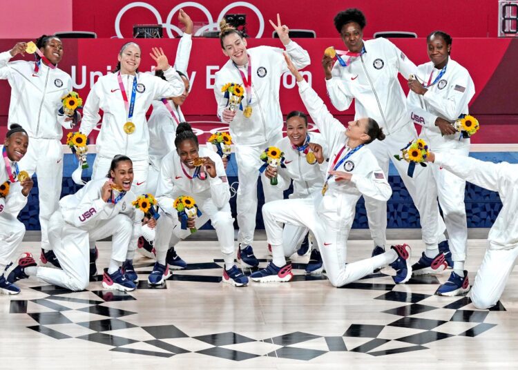 United States players pose with their gold medals during the medal ceremony for women's basketball at the 2020 Summer Olympics in Saitama, Japan.