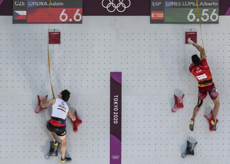 Czech Republic's Adam Ondra (L) and Alberto Gines Lopez, of Spain, compete during the speed portion of the men's sport climbing final at the 2020 Summer Olympics.