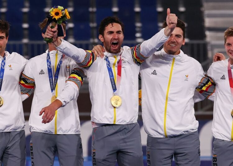 Loick Luypaert of Belgium reacts as they pose for pictures after receiving their gold medals.