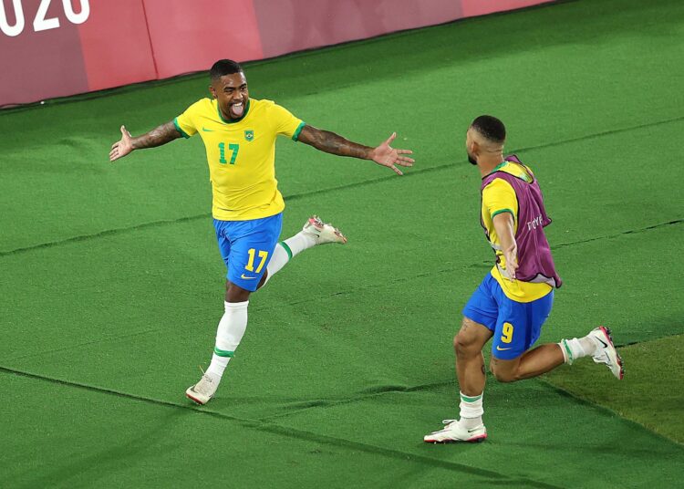 Malcom (L) of Brazil celebrates after scoring his side's second goal during the men's gold medal match against Spain in Yokohama.