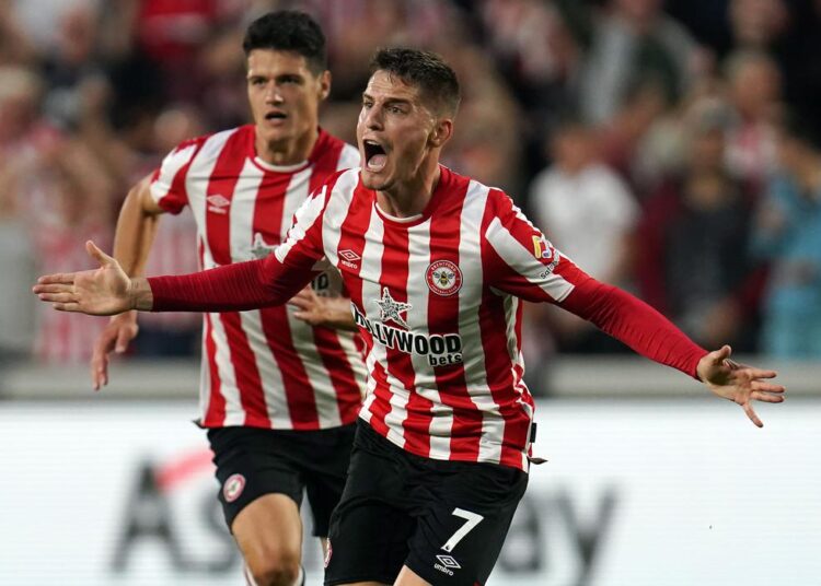 Brentford's players celebrate after scoring their side's second goal against Arsenal in London.