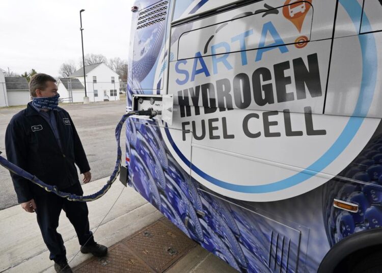 Kevin Baker, a maintenance technician, refuels a hydrogen fuel cell bus, Tuesday, March 16, 2021, in Canton, Ohio.