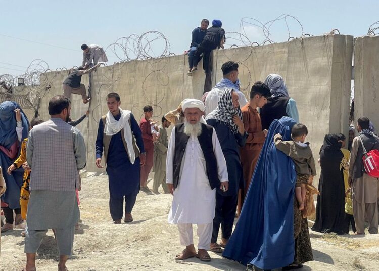 People try to get inside Hamid Karzai International Airport in Kabul, Afghanistan.