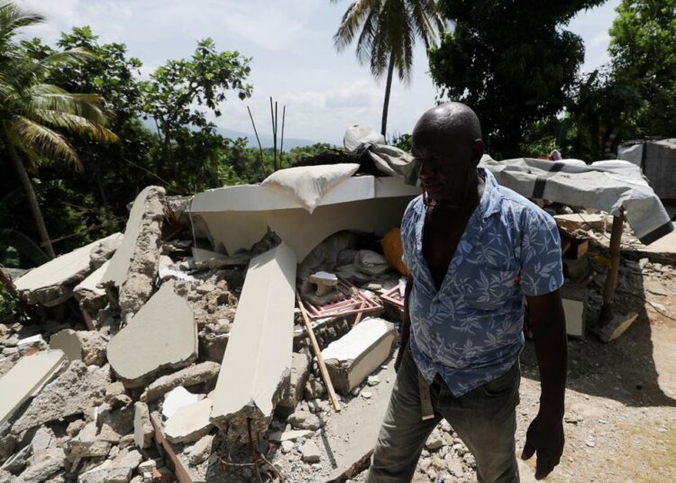 A file photo of a resident walking among destroyed houses, after the earthquake that took place on August 14th, in Marceline, near Les Cayes, Haiti.
