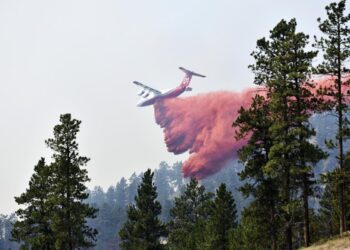 Wildfire bears down on Montana towns as West burns
