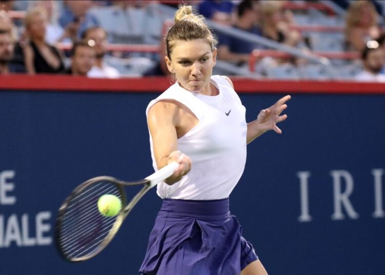Aug 11, 2021; Montreal, Quebec, Canada; Simona Halep from Romania hits a shot against Danielle Collins from USA (not pictured) during the second round play at Stade IGA. Mandatory Credit: Jean-Yves Ahern-USA TODAY Sports