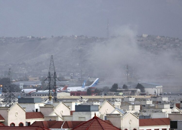 Smoke rises from a blast outside the airport in Kabul on Thursday.