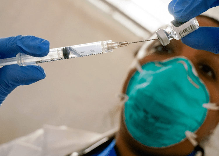 Some in US getting COVID-19 boosters without FDA approval 1 - Egyptian Gazette A file photo, dated on Jan. 15, 2021, showing Dr. Yomaris Pena, Internal Medicine Physician with Somos Community Care at a COVID-19 extracts the last bit of Pfizer-BioNTech COVID-19 Vaccine out of a vial so as not to waste it at a vaccination site at the Corsi Houses in the East Harlem neighborhood of New York.