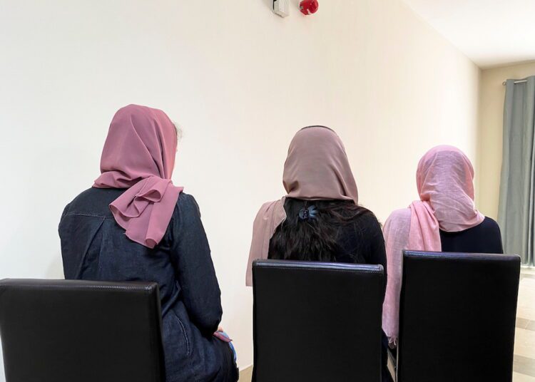 Three young Afghan female university students who have fled their country pose for a photo, hiding their identity over safety concerns for family in Afghanistan, at a residential compound in Doha, Qatar, yesterday.