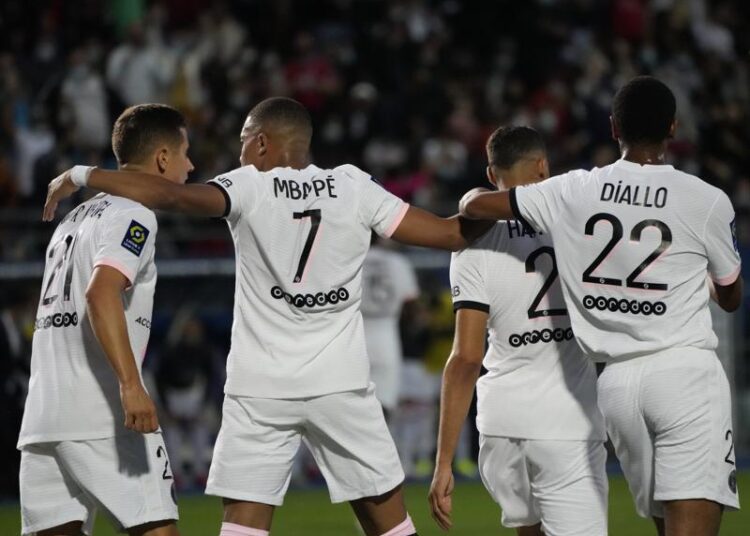 PSG's Achraf Hakimi, second right, celebrates with teammates after scoring his side's opening goal during the French League One soccer match between Troyes and Paris Saint Germain, at the Stade de l'Aube, in Troyes, France, Saturday, Aug. 7, 2021.