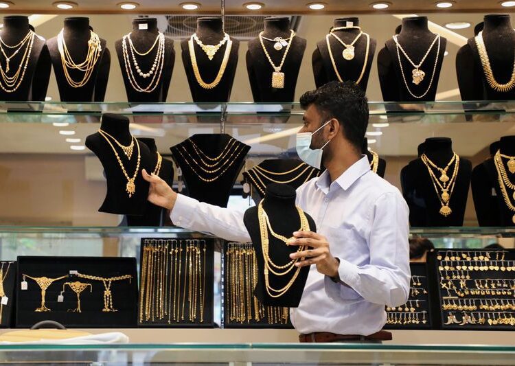 A vendor wearing a protective mask arranges gold jewellery displayed at VJ Gold and Diamond jewellery shop, amid the coronavirus disease (COVID-19) outbreak, in Kuala Lumpur, Malaysia August 10, 2020.