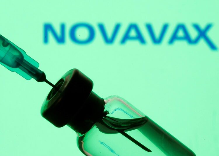 A vial and syringe are seen in front of a displayed Novavax logo in this illustration taken January 11, 2021.