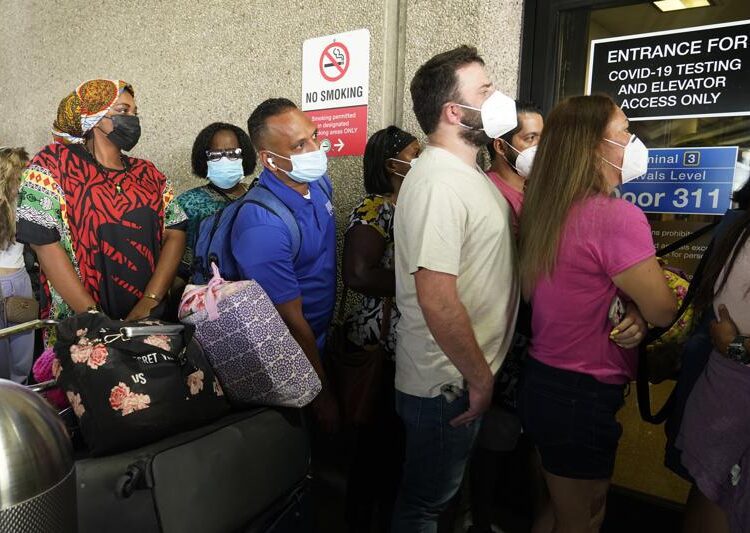 Passengers wait in a long line to get a COVID-19 test to travel overseas at Fort Lauderdale-Hollywood International Airport, yesterday, in Fort Lauderdale, Fla. Recent flight cancelations caused many passengers to redo their tests while others were unable to get the test locally due to long lines caused by the surge of the Delta variant.