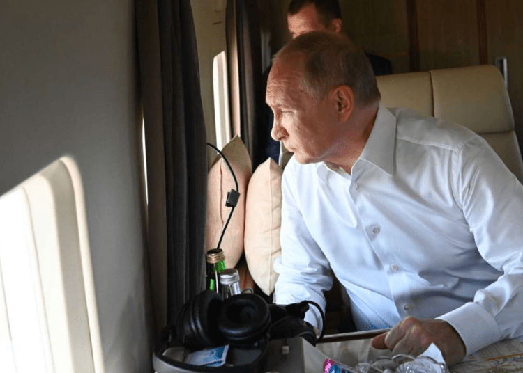 Russian President Vladimir Putin looks through a helicopter's window watching a damage from wildfires in the Chelyabinsk Region, Russia, Friday, Aug. 6, 2021.