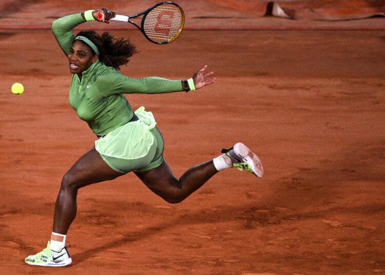 Serena Williams of the US returns the ball to Romania's Irina Begu during their women's singles first round tennis match at the court Philippe Chatrier on Day 2 of The Roland Garros 2021 French Open tennis tournament in Paris on May 31, 2021.