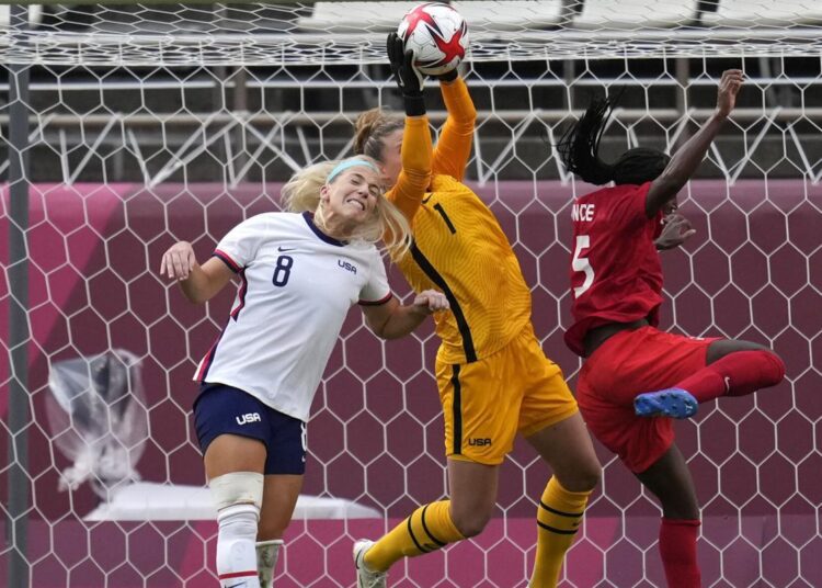 United States' goalkeeper Alyssa Naeher, center, catches a ball during a women's semifinal soccer match against Canada at the 2020 Summer Olympics, Monday, Aug. 2, 2021, in Kashima, Japan.
