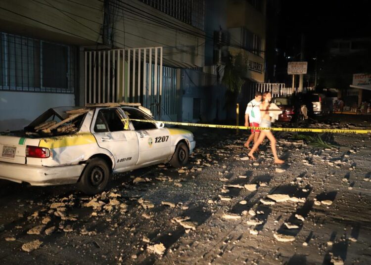 Powerful earthquake near Mexico’s Acapulco kills at least 1 1 - Egyptian Gazette A couple walks past a taxi cab that was damaged by falling debris after a strong earthquake in Acapulco, Mexico, Tuesday, Sept. 7, 2021. The quake struck southern Mexico near the resort of Acapulco, causing buildings to rock and sway in Mexico City nearly 200 miles away.