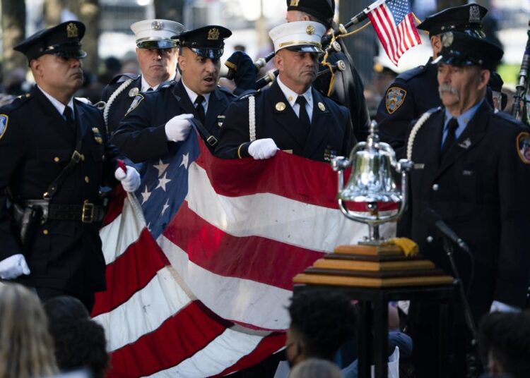 A memorial flag is brought onto the stage during ceremonies to commemorate the 20th anniversary of the Sept. 11 terrorist attacks, Saturday, Sept. 11, 2021, at the National September 11 Memorial & Museum in New York.