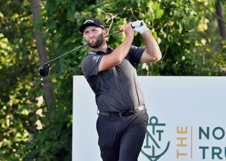 Jon Rahm watches his tee shot on the 18th hole during the first round of The Northern Trust golf tournament at the Liberty National Golf Club.