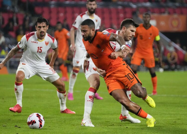 Memphis Depay of the Netherlands is fouled in the penalty box by Montenegro's Dusan Lagator, during the World Cup 2022 group G qualifying match in Eindhoven.