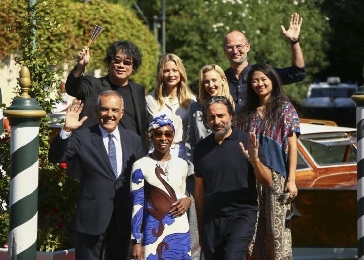 Jury President Bong Joon Ho, from top left, Jury members Virginie Efira, Sarah Gadon, Alexander Nanau, director of the Venice Film festival Alberto Barbera, from bottom left, jury members Cynthia Erivo, Saverio Costanzo and Chloe Zhao pose for photographers upon arrival at the 78th edition of the Venice Film Festival in Venice, Italy, Wednesday, Sep, 1, 2021.