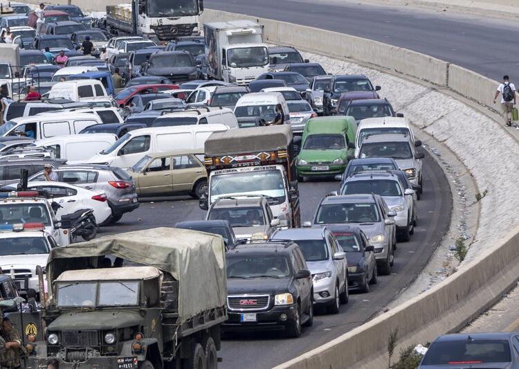 High-level Lebanese delegation arrives in Syria to talk fuel 1 - Egyptian Gazette A general view of a petrol station on the main highway that link the Capital Beirut to south Lebanon as a man holds a gallon of fuel, right, while cars come from every direction to try and fill their tanks with gasoline, in the coastal town of Jiyeh, south of Beirut, Lebanon, Friday, Sept. 3, 2021.