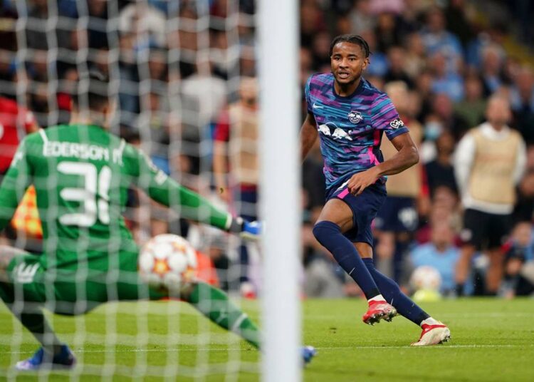 RB Leipzig's Christopher Nkunku scores during the Champions League Group A match against Manchester City at the Etihad Stadium, Manchester.