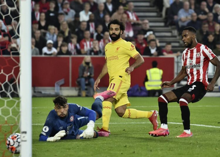 Liverpool's Mohamed Salah (C) scores his side's second goal during the English Premier League soccer match against Brentford in London.