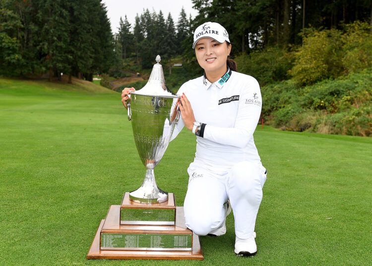 Jin Young Ko, of South Korea, poses with the trophy after winning the LPGA Cambia Portland Classic.