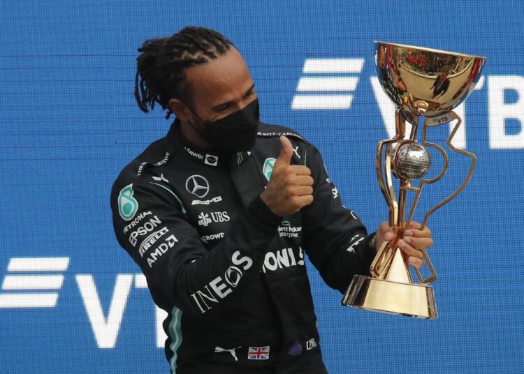 Lewis Hamilton wins 100th F1 race 1 - Egyptian Gazette Mercedes' Lewis Hamilton celebrates with the trophy on the podium after winning the Russian Grand Prix at the Sochi Autodrom, Russia.
