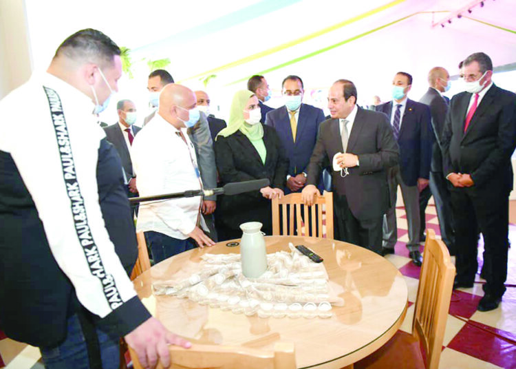 President Sisi checking Abwab El-Khair products during his tour in NAC on Sunday.