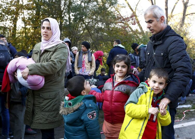 File photo showing Syrian migrant Zake Khalil (R), his wife Nagwa (L) and their four children Joan (3rd L), Torin (3rd R), Ellen (2nd R) and newborn Hevin arrive at the Austrian-German border in Achleiten near Passau, Germany in 2015.